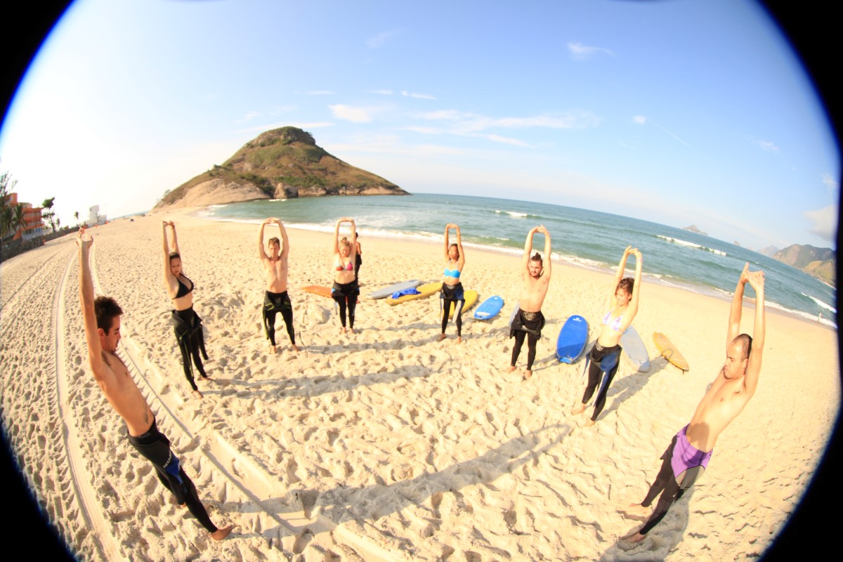 stretching on beach surf'n'stay rio surf camp summer retreats for adults lessons children teen young adult best nomad kid bali canggu beginners uluwatu france moliets portugal algarve lisbon 4
