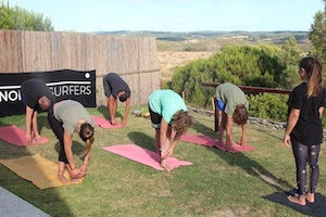 stretching nomad surf camp - young adults 18 - 21 years old, algarve, portugal retreats for adults surf camp lessons children teen summer young adult best nomad kid bali canggu beginners uluwatu france moliets lisbon