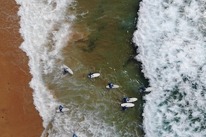 surfing aerial view nomad surf camp - young adults - lisbon - erasmus - university students retreats for adults surf camp lessons children teen summer young adult best nomad kid bali canggu beginners uluwatu france moliets portugal algarve