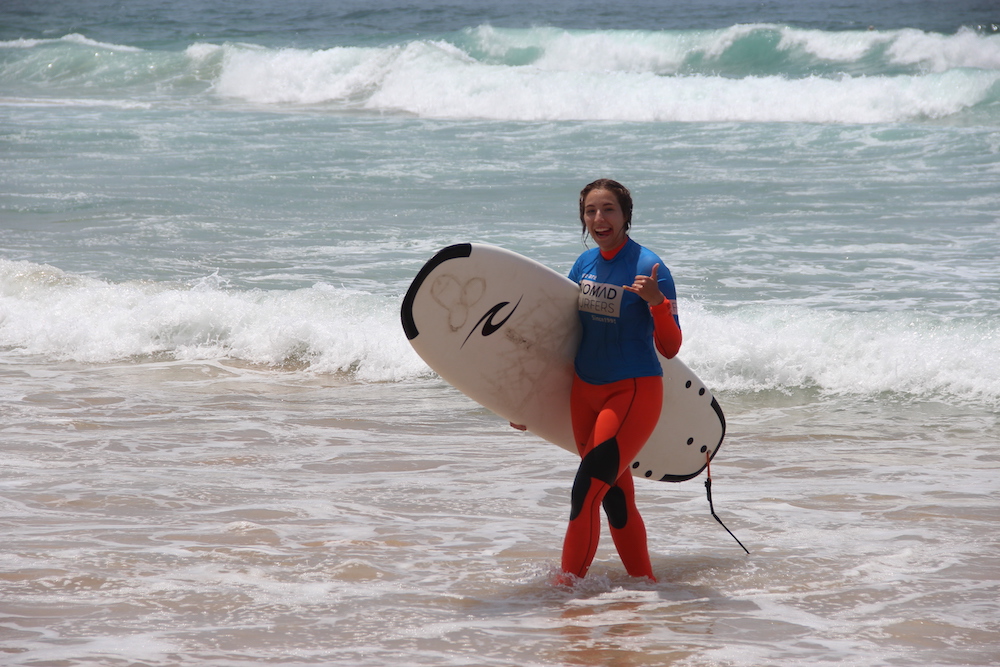 happy girl 10 nomad surf camp - young adults - lisbon - erasmus - university students retreats for adults surf camp lessons children teen summer young adult best nomad kid bali canggu beginners uluwatu france moliets portugal algarve