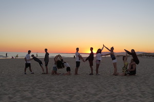 play on beach sunset surf stretching nomad surf camp - young adults - lisbon - erasmus - university students retreats for adults surf camp lessons children teen summer young adult best nomad kid bali canggu beginners uluwatu france moliets portugal algarve