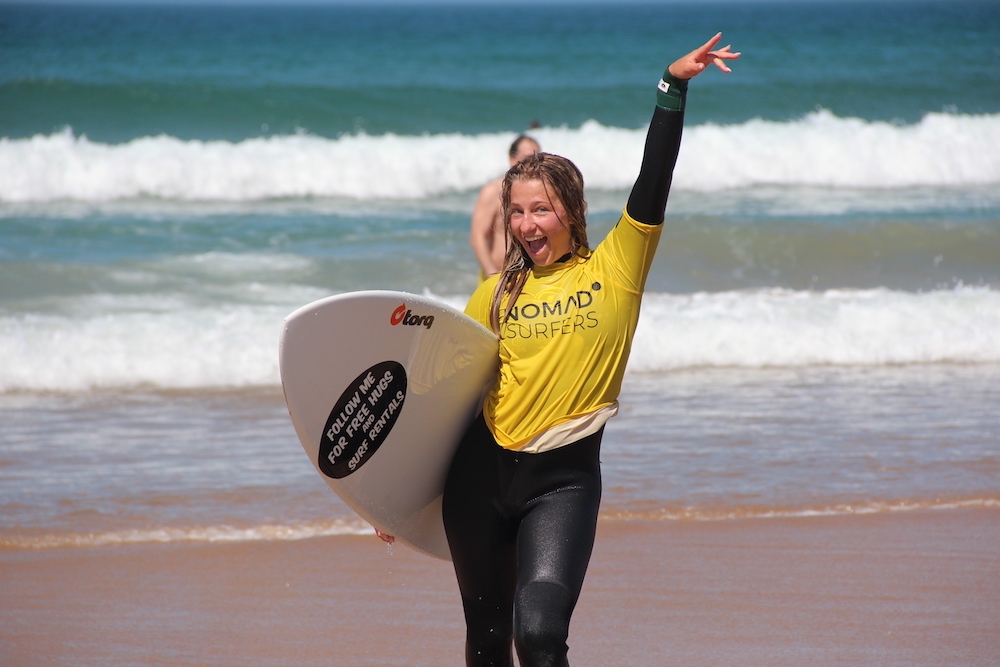 happy girl 2 nomad surf camp - young adults - lisbon - erasmus - university students retreats for adults surf camp lessons children teen summer young adult best nomad kid bali canggu beginners uluwatu france moliets portugal algarve