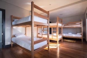 bedroom with bunkbeds nomad surf camp - young adults - lisbon - erasmus - university students retreats for adults surf camp lessons children teen summer young adult best nomad kid bali canggu beginners uluwatu france moliets portugal algarve