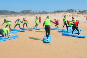 surf lesson nomad surf camp - young adults - cantabria retreats for adults surf camp lessons summer young adult best nomad kid bali canggu beginners uluwatu france moliets portugal algarve lisbon