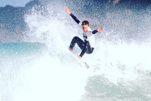 boy surfing nomad surf camp - young adults - cantabria retreats for adults surf camp lessons summer young adult best nomad kid bali canggu beginners uluwatu france moliets portugal algarve lisbon